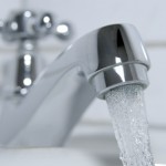 Badekappe mit klarem Wasser abspuelen